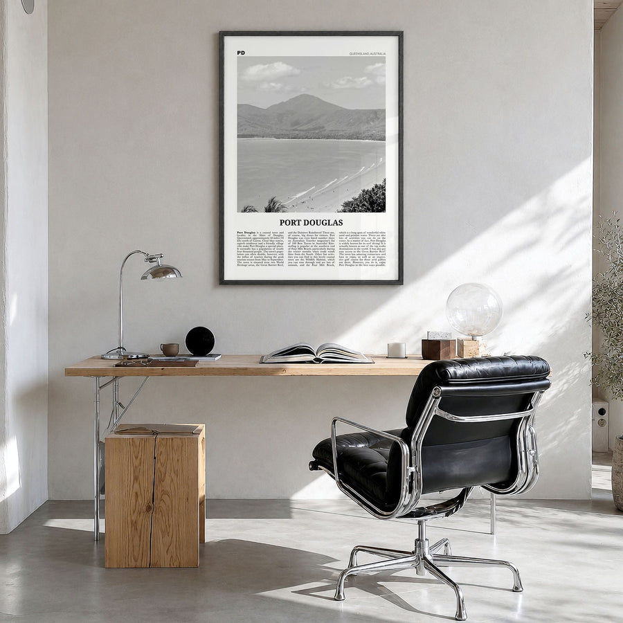Port Douglas Newspaper Poster in a black wood frame, hanging in a bright home office