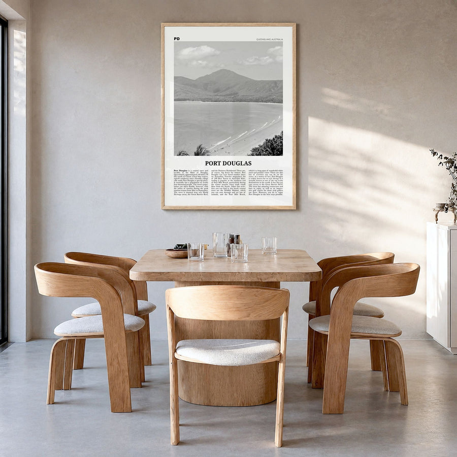 Port Douglas Newspaper Poster in a natural wood frame, hanging in a dining room