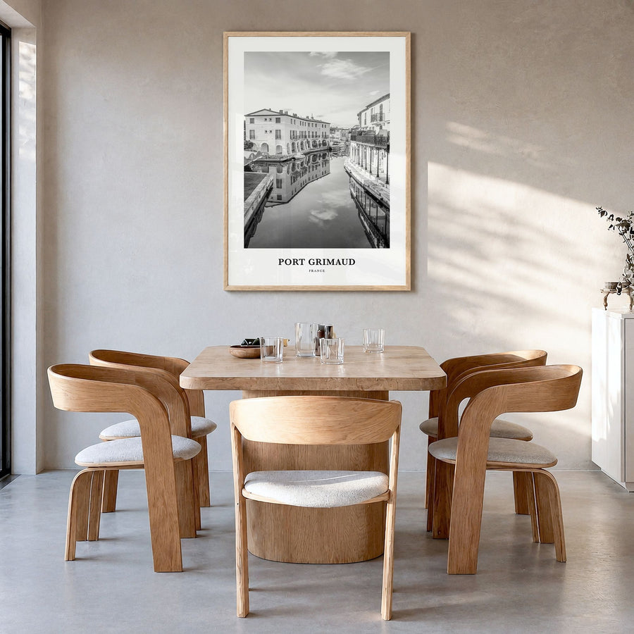 Port Grimaud Classic Poster in a natural wood frame, hanging in a dining room
