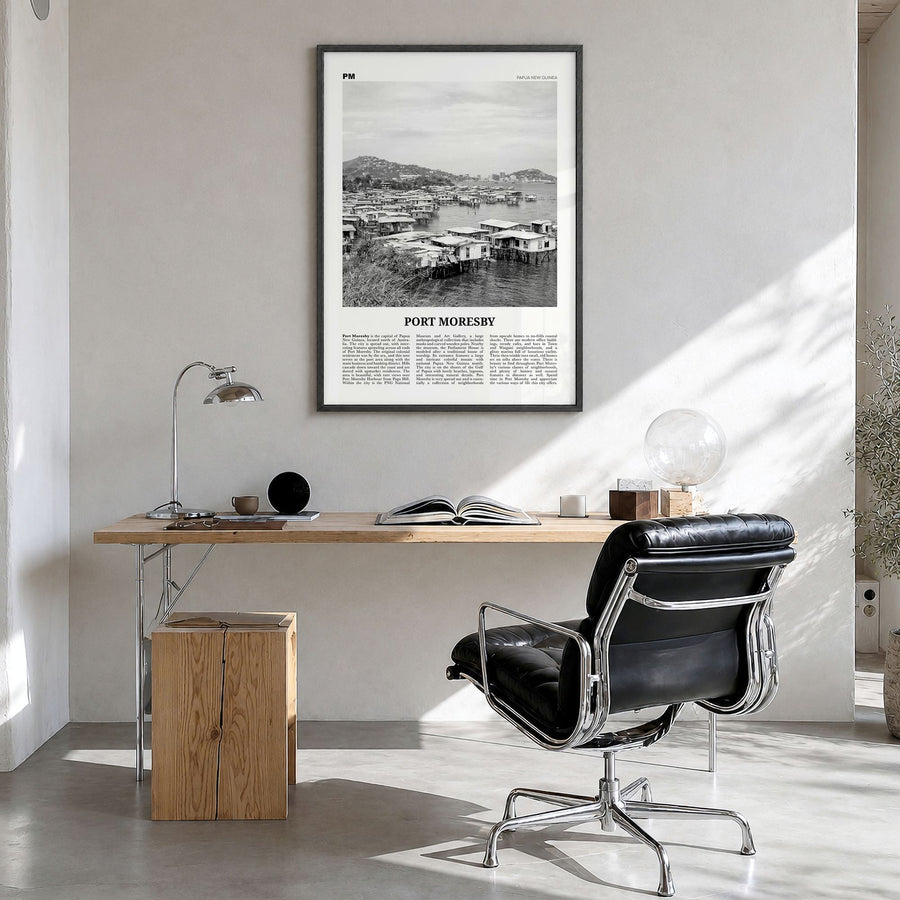 Port Moresby Newspaper Poster in a black wood frame, hanging in a bright home office