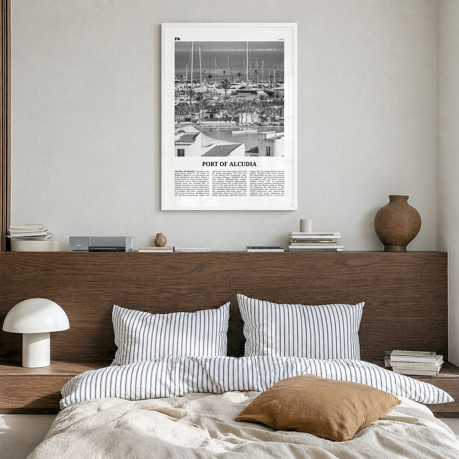 Port of Alcudia Newspaper Poster in a white wood frame, hanging in a bedroom