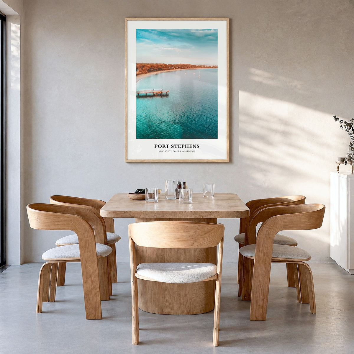Port Stephens Classic Poster in a natural wood frame, hanging in a dining room