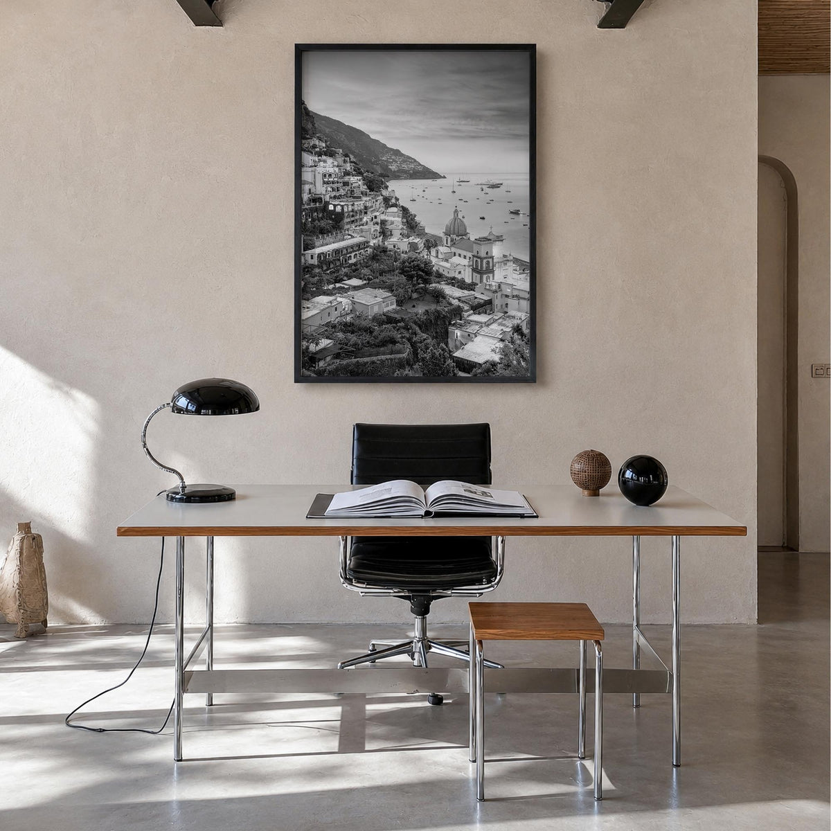 Positano no. 1 black & white photo poster of Italy – vertical wall art in black wood frame, hanging on wall