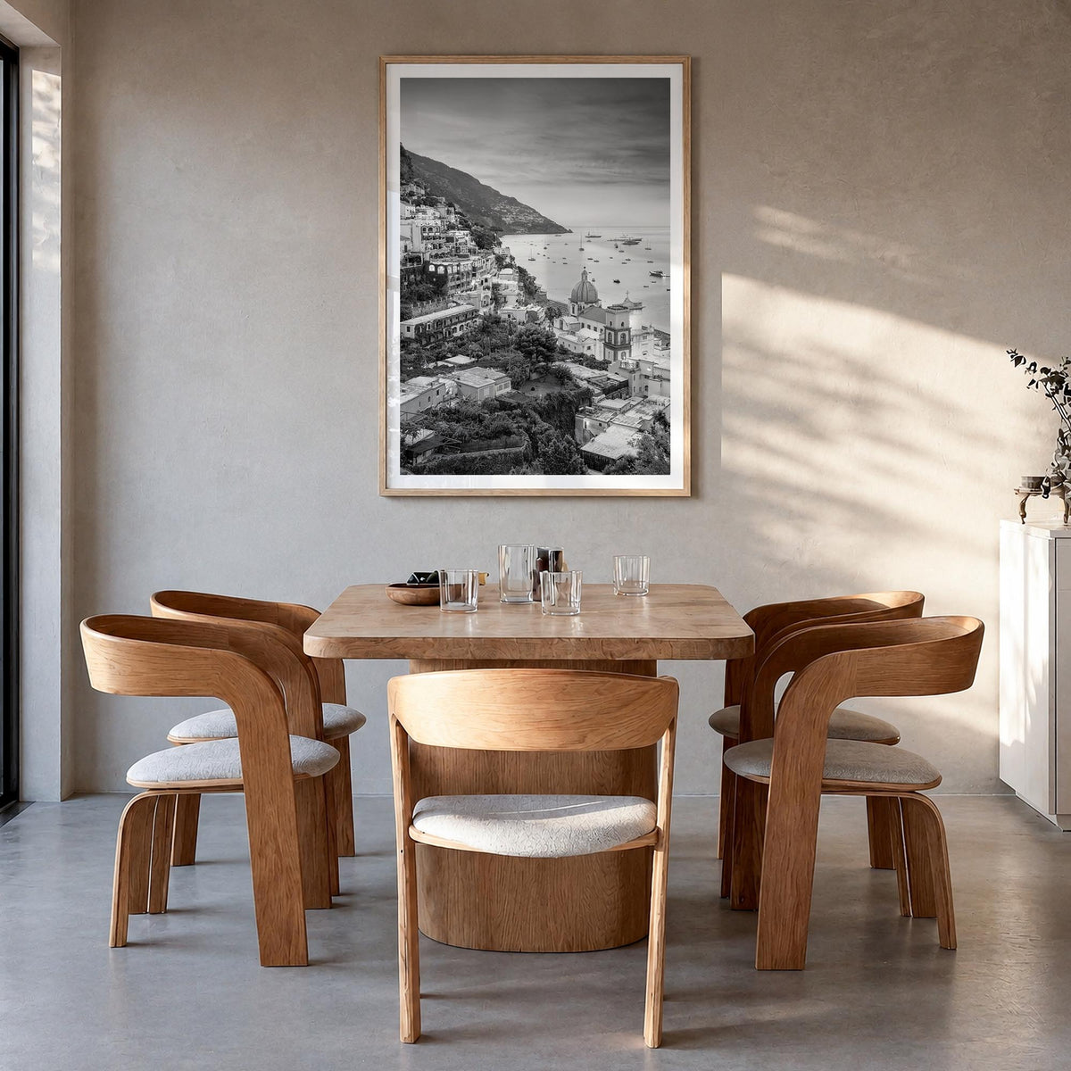 Positano no. 1 black & white photo poster of Italy – vertical wall art in natural wood frame with white border, hanging on wa