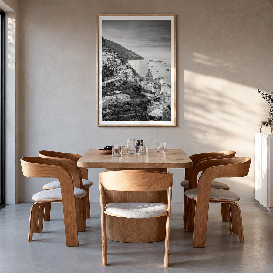Positano no. 1 black & white photo poster of Italy – vertical wall art in natural wood frame with white border, hanging on wa