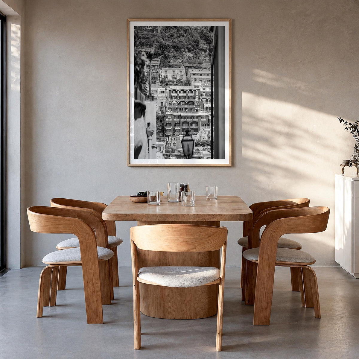Positano no. 2 black & white photo poster of Italy – vertical wall art in natural wood frame with white border, hanging on wa