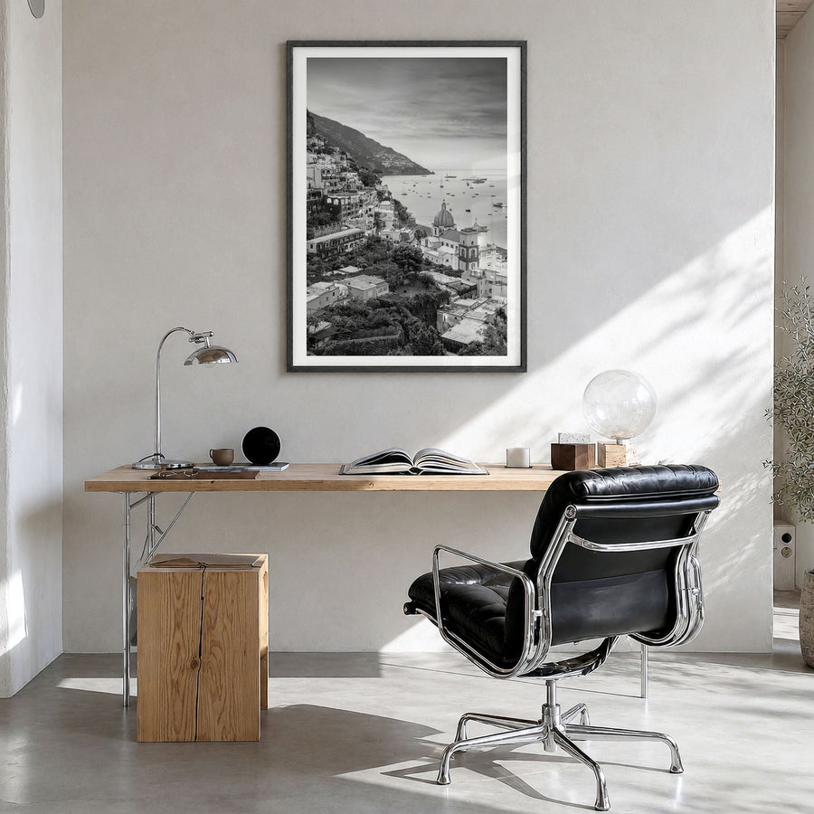 Positano Photo No 1 Poster in a black wood frame, hanging in a bright home office, white border
