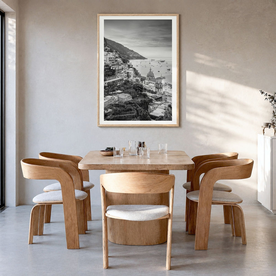 Positano Photo No 1 Poster in a natural wood frame, hanging in a dining room, white border