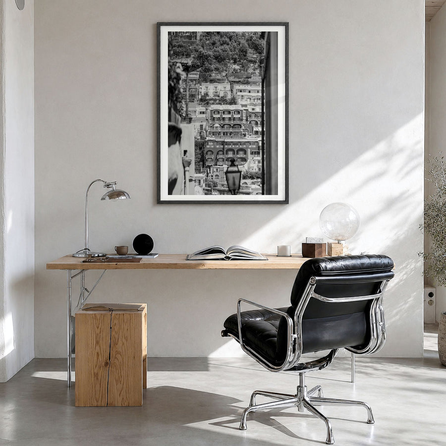 Positano Photo No 2 Poster in a black wood frame, hanging in a bright home office, white border