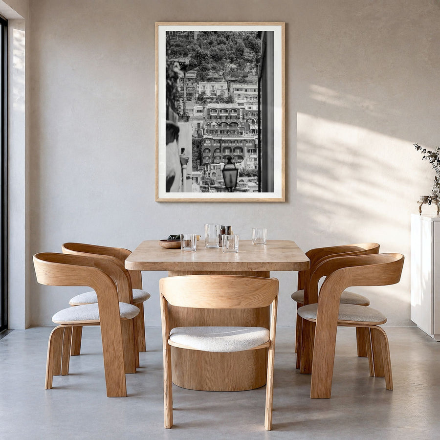 Positano Photo No 2 Poster in a natural wood frame, hanging in a dining room, white border