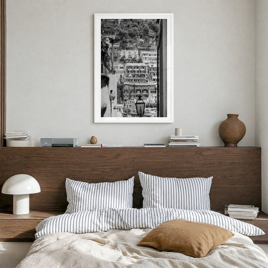 Positano Photo No 2 Poster in a white wood frame, hanging in a bedroom, white border