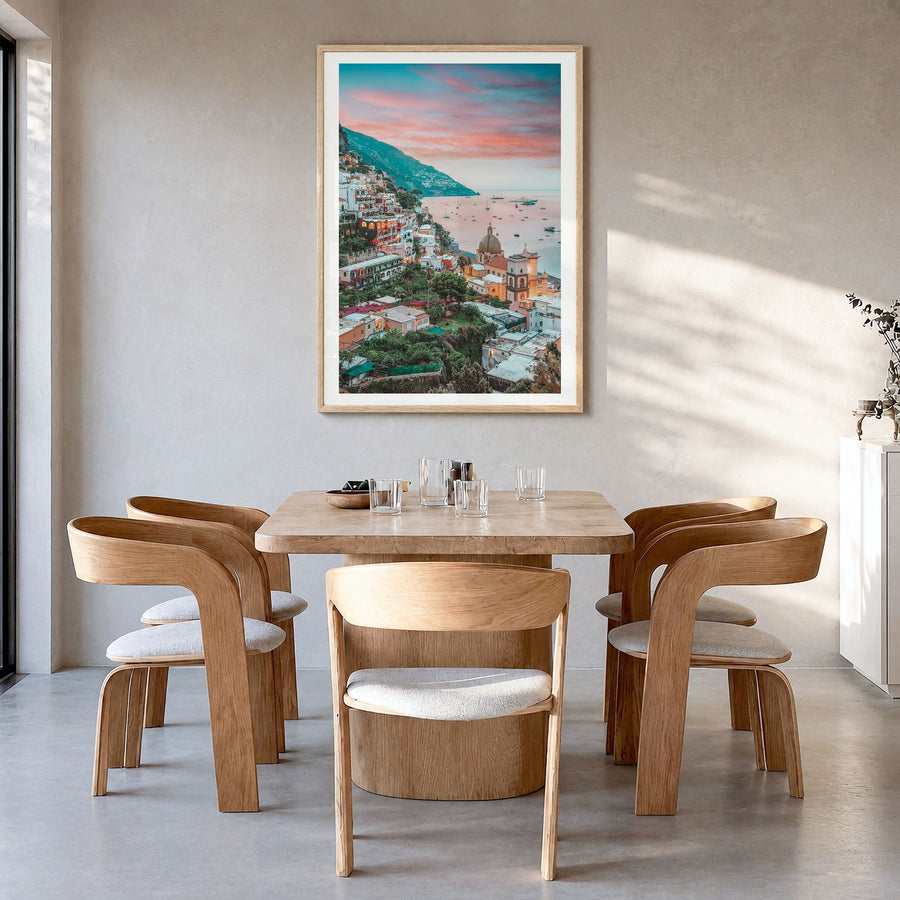 Positano Photo No 4 Poster in a natural wood frame, hanging in a dining room, white border