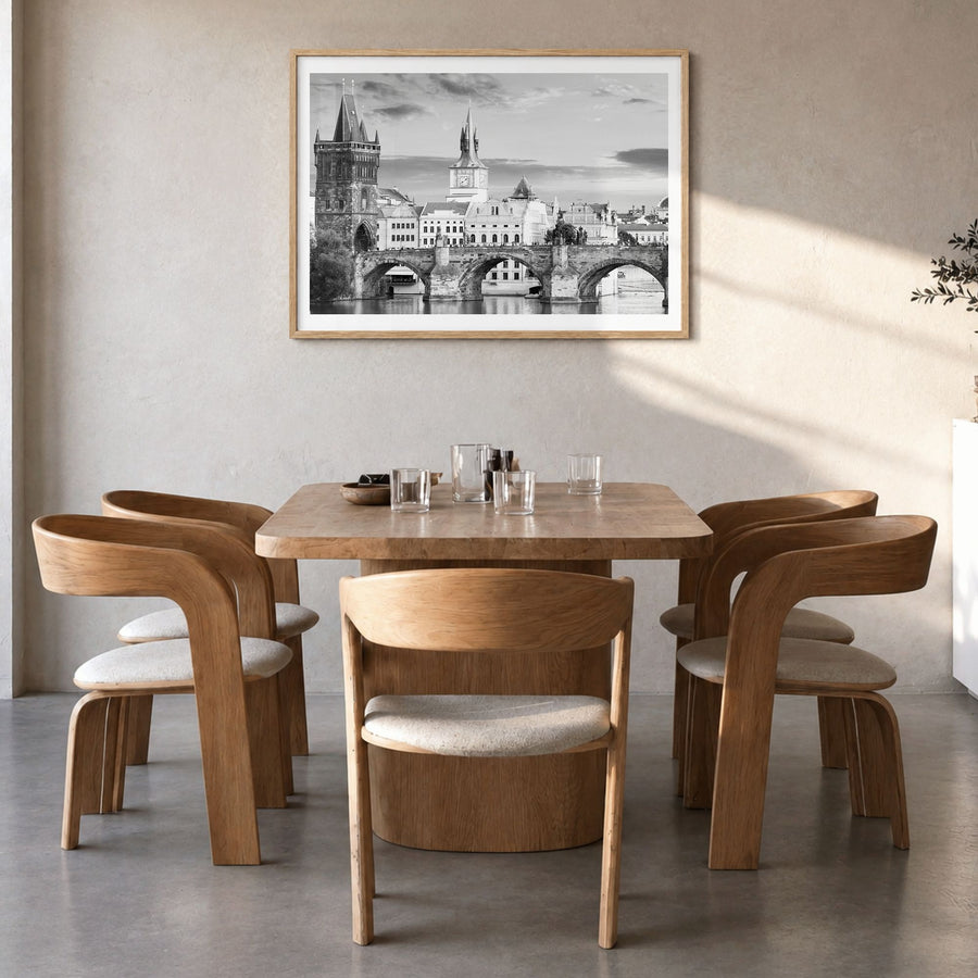 Prague Photo Poster in a natural wood frame, hanging in a dining room, white border