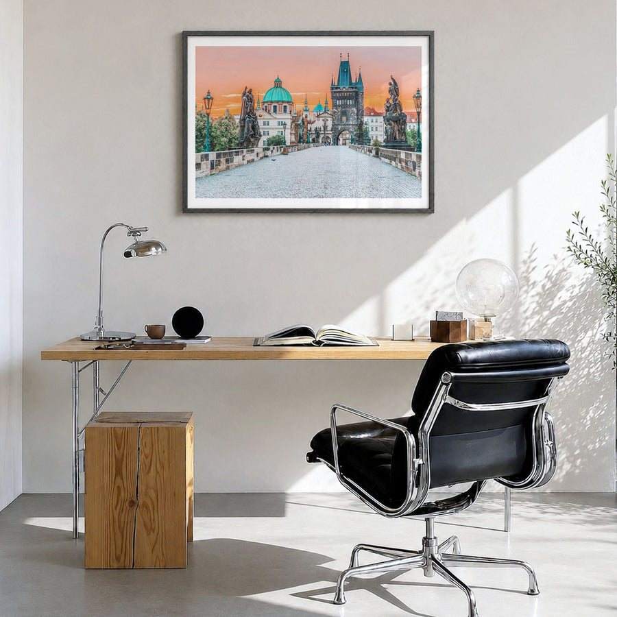Prague Photo Poster in a black wood frame, hanging in a bright home office, white border