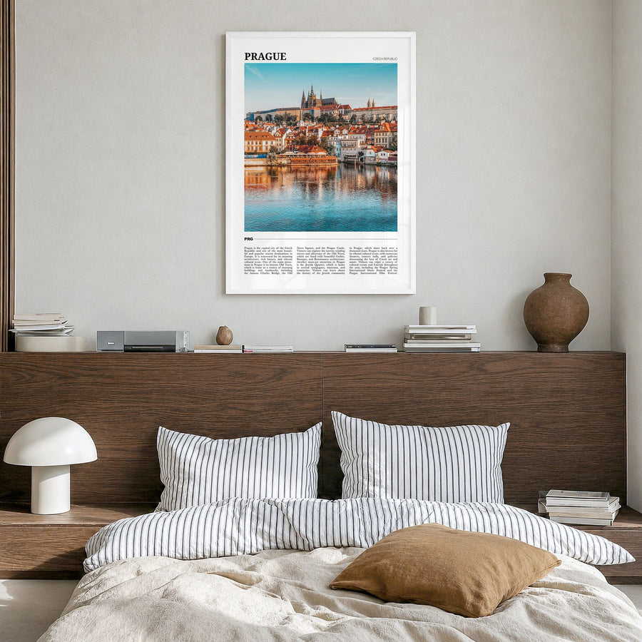 Prague Travel Poster in a white wood frame, hanging in a bedroom