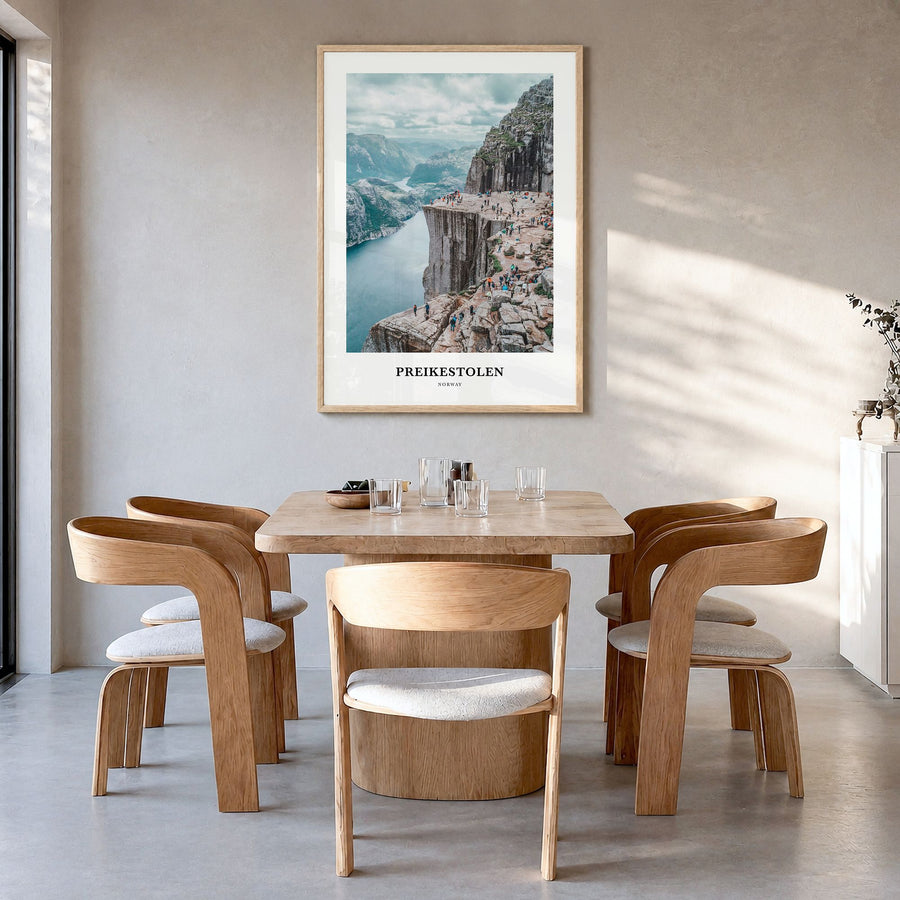 Preikestolen Classic Poster in a natural wood frame, hanging in a dining room
