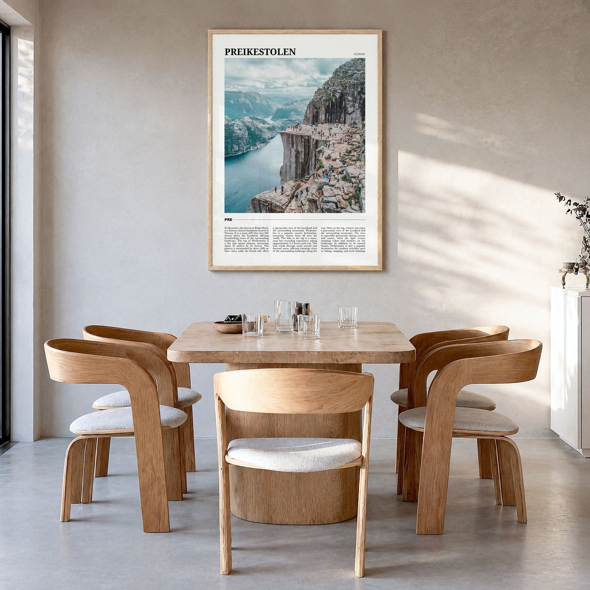 Preikestolen Travel Poster in a natural wood frame, hanging in a dining room