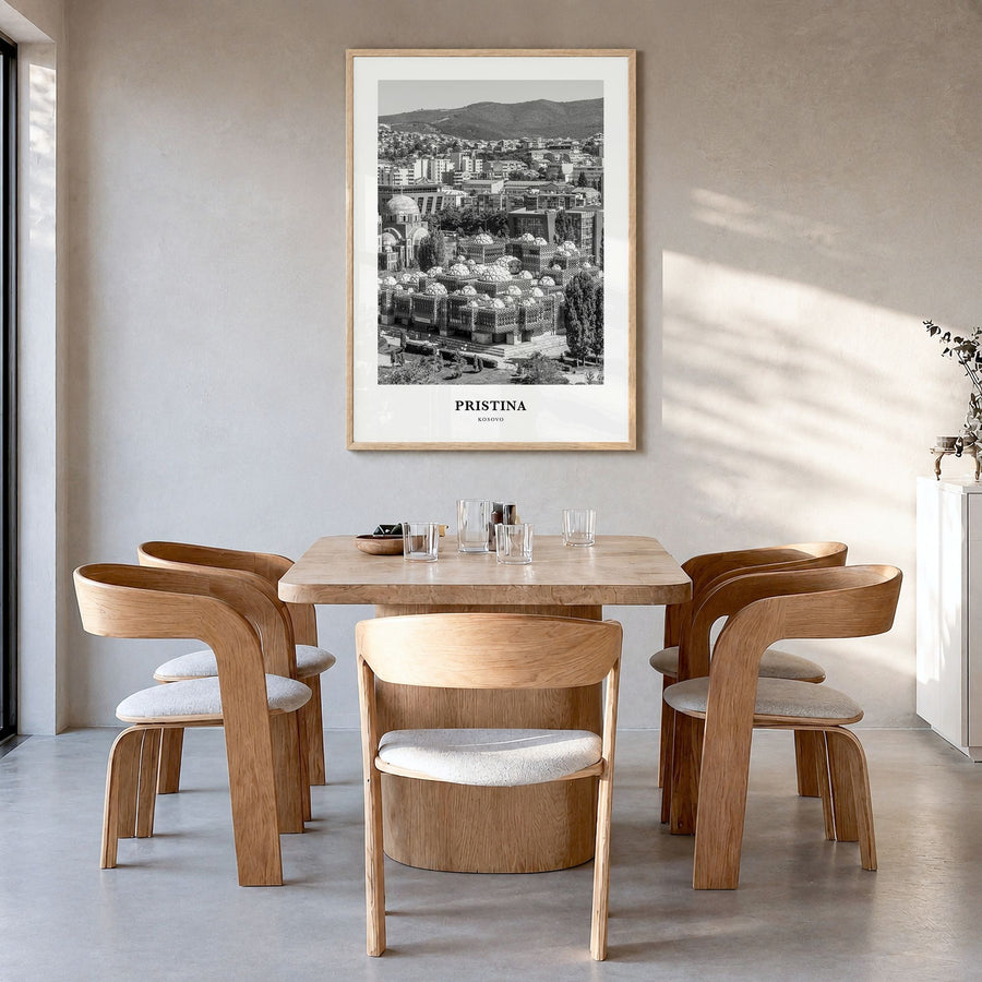 Pristina Classic Poster in a natural wood frame, hanging in a dining room