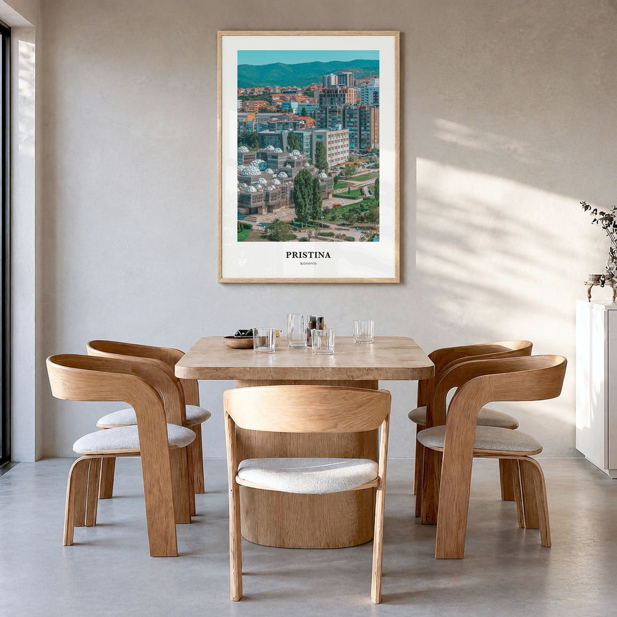 Pristina Classic Poster in a natural wood frame, hanging in a dining room