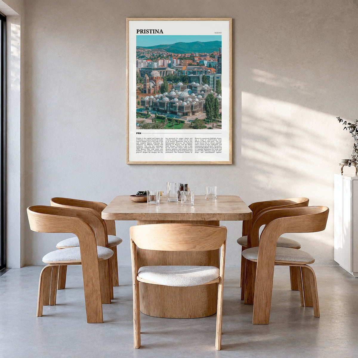 Pristina Travel Poster in a natural wood frame, hanging in a dining room