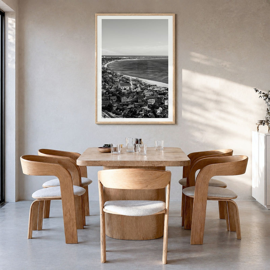 Provincetown Photo Poster in a natural wood frame, hanging in a dining room, white border