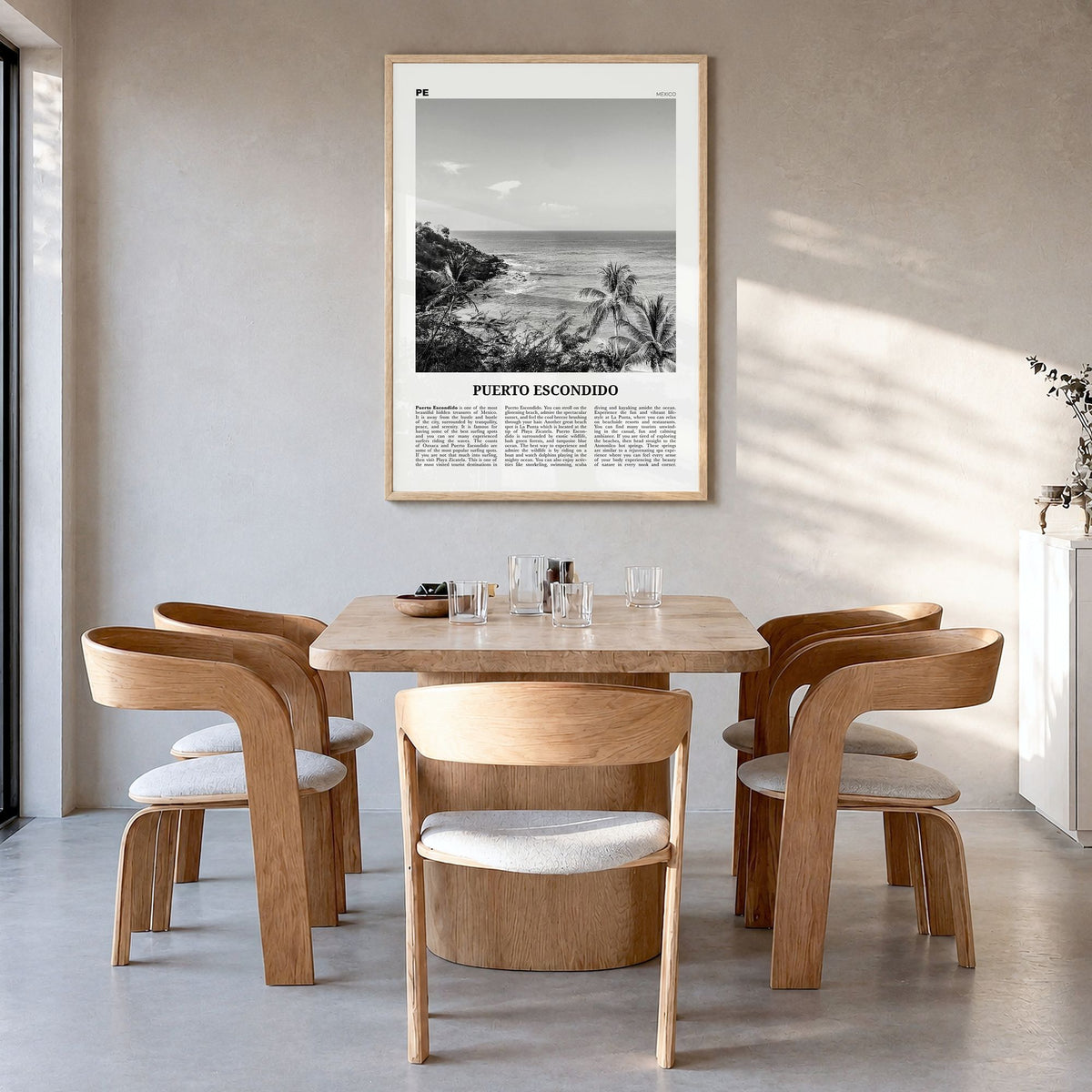Puerto Escondido Newspaper Poster in a natural wood frame, hanging in a dining room