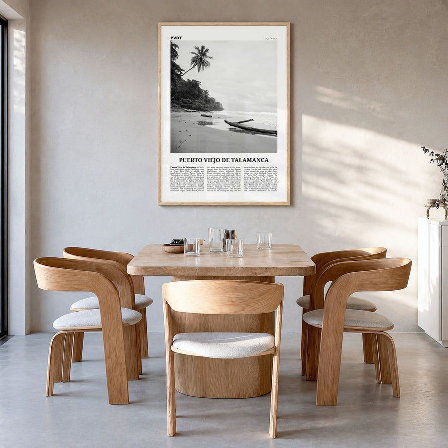Puerto Viejo de Talamanca Newspaper Poster in a natural wood frame, hanging in a dining room