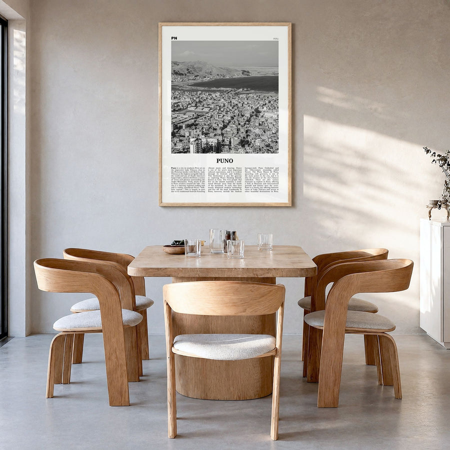 Puno Newspaper Poster in a natural wood frame, hanging in a dining room