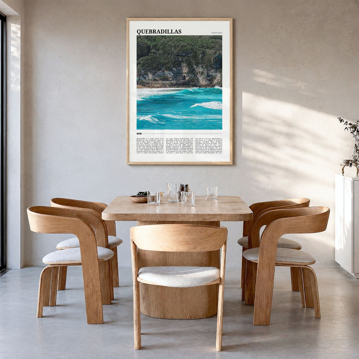 Quebradillas Travel Poster in a natural wood frame, hanging in a dining room