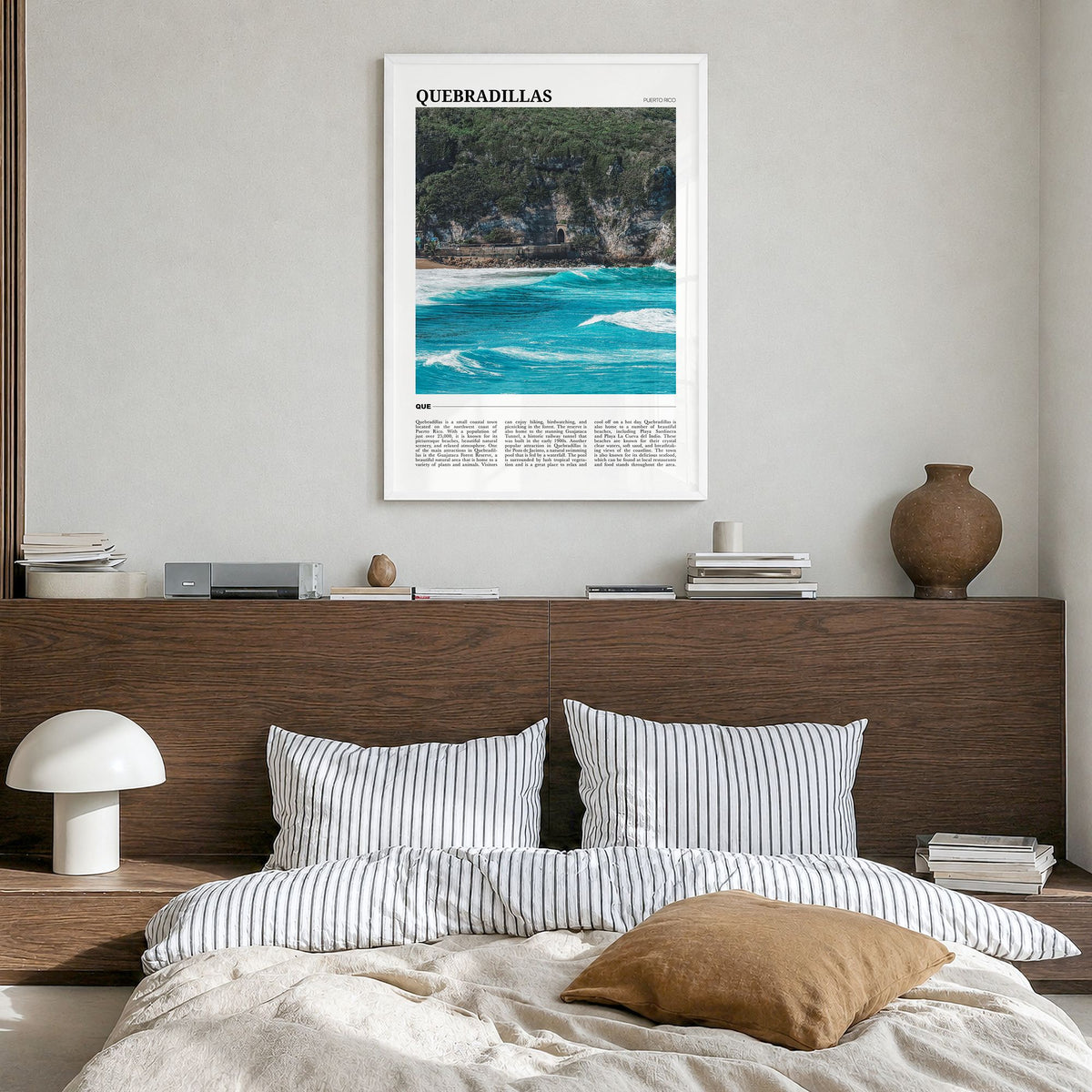 Quebradillas Travel Poster in a white wood frame, hanging in a bedroom