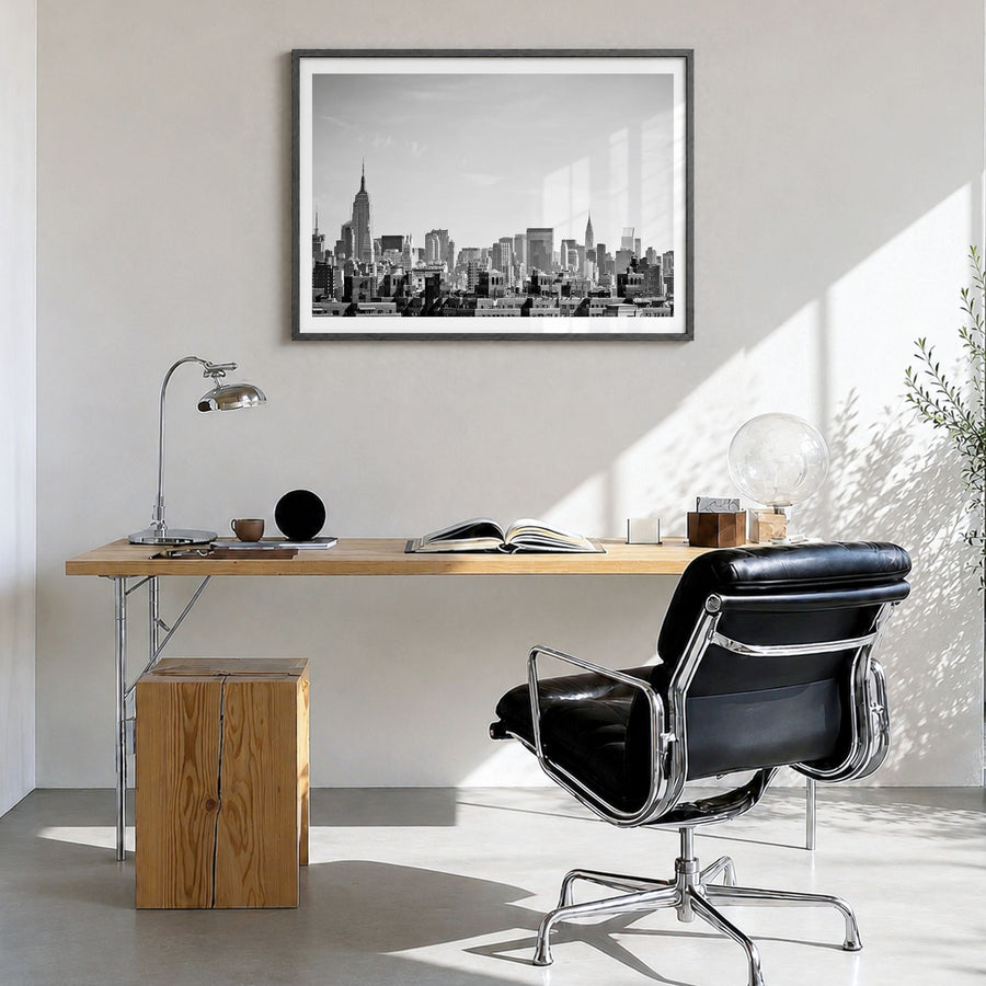 Queens, New York Photo Poster in a black wood frame, hanging in a bright home office, white border
