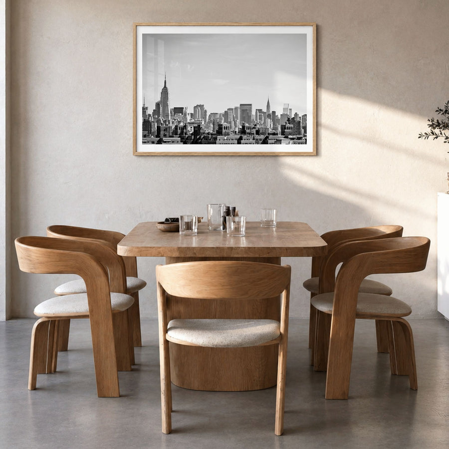 Queens, New York Photo Poster in a natural wood frame, hanging in a dining room, white border