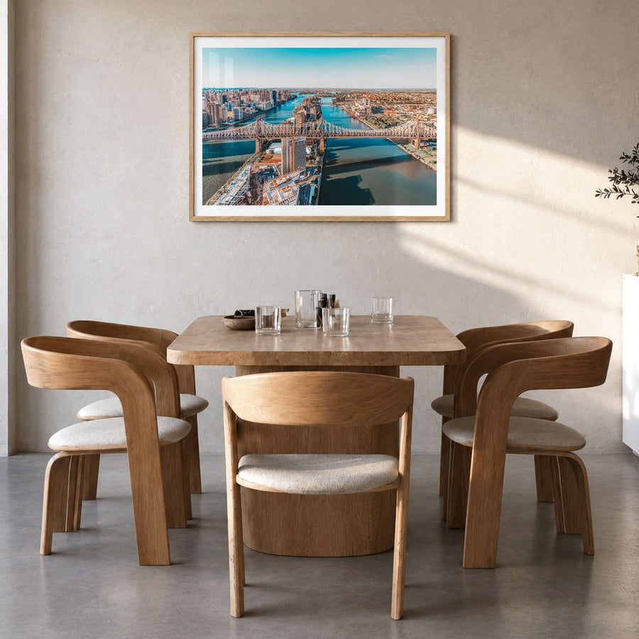 Queens, New York Photo Poster in a natural wood frame, hanging in a dining room, white border