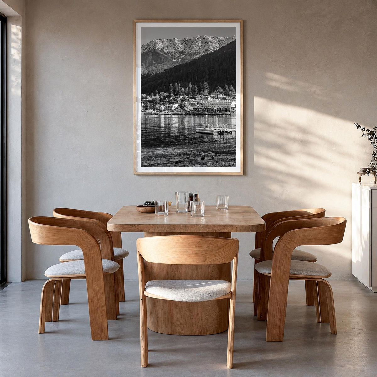 Queenstown black & white photo poster of New Zealand – vertical wall art in natural wood frame with white border, hanging on 