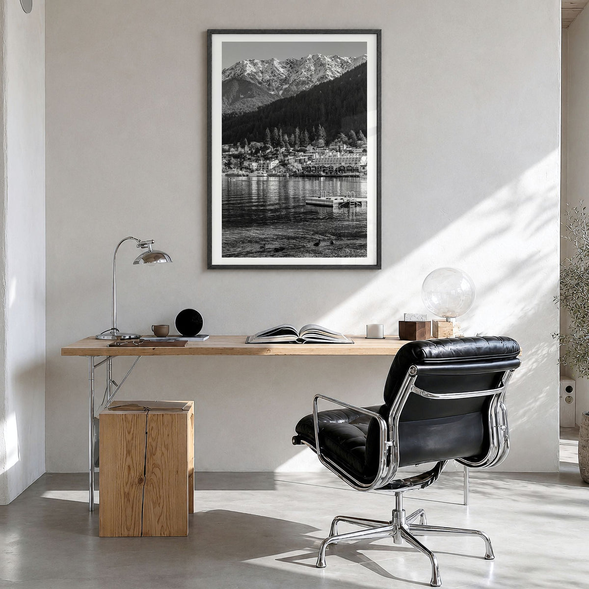 Queenstown Photo Poster in a black wood frame, hanging in a bright home office, white border