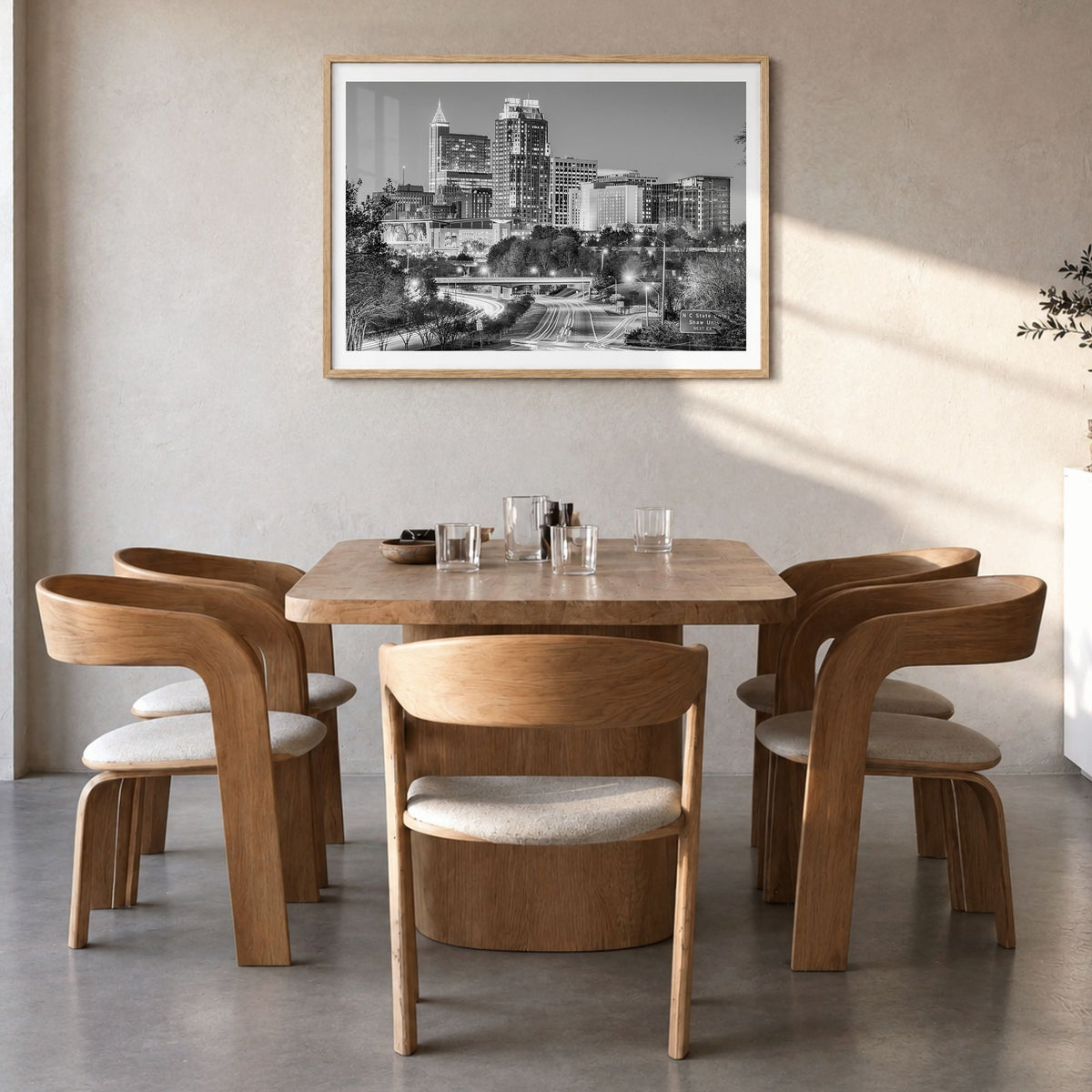 Raleigh Photo Poster in a natural wood frame, hanging in a dining room, white border
