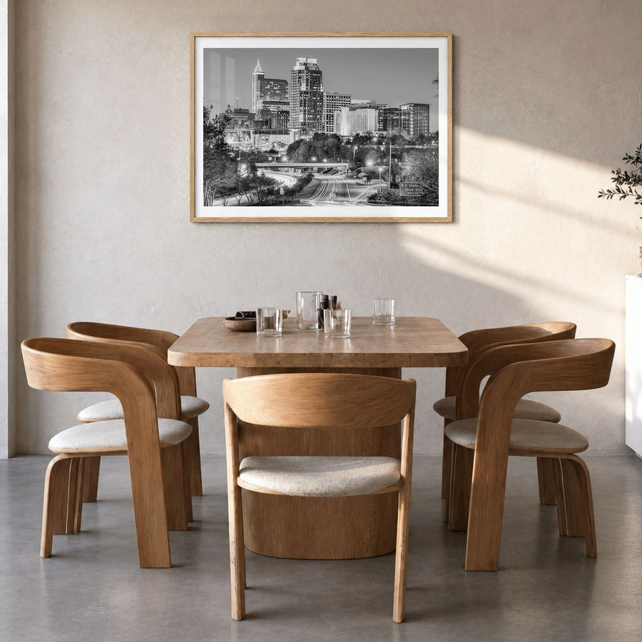 Raleigh Photo Poster in a natural wood frame, hanging in a dining room, white border