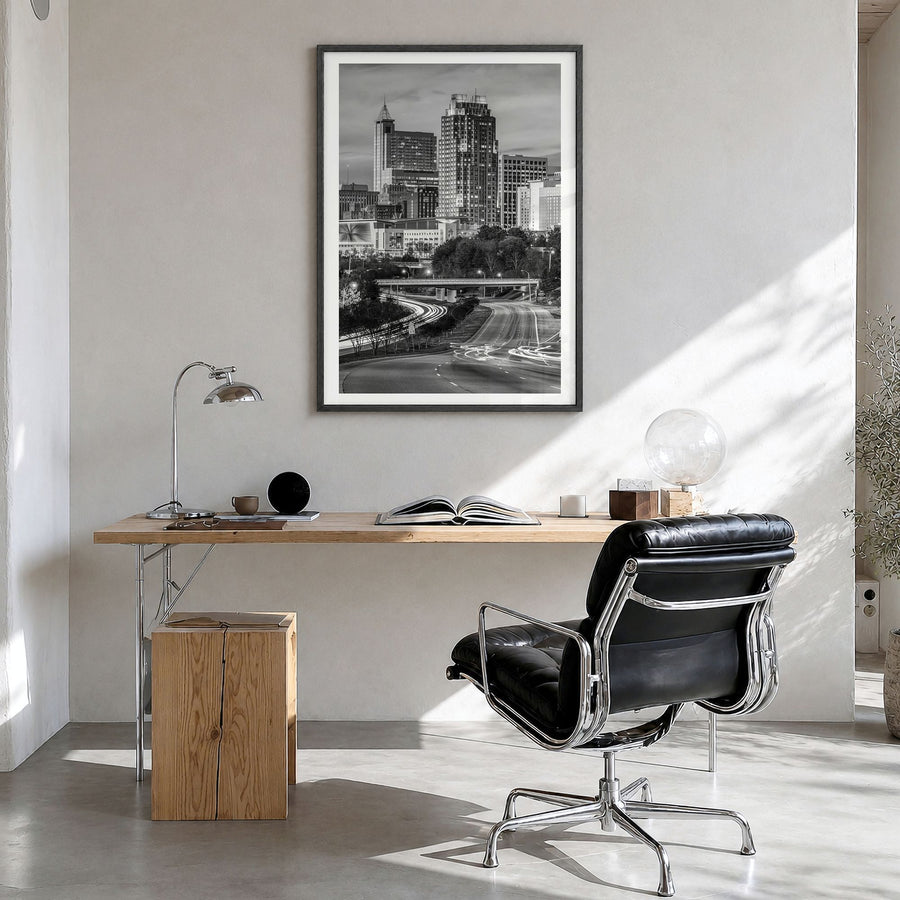 Raleigh Photo No 2 Poster in a black wood frame, hanging in a bright home office, white border