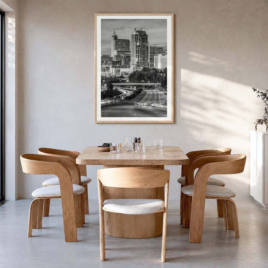 Raleigh Photo No 2 Poster in a natural wood frame, hanging in a dining room, white border