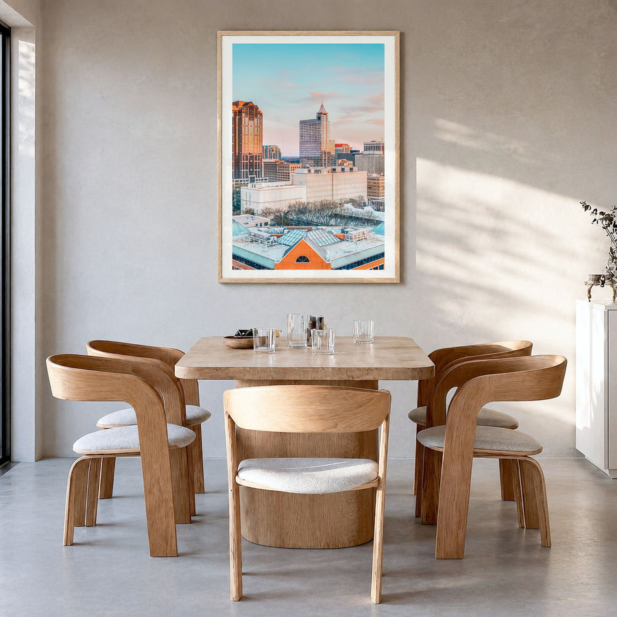 Raleigh Photo No 1 Poster in a natural wood frame, hanging in a dining room, white border