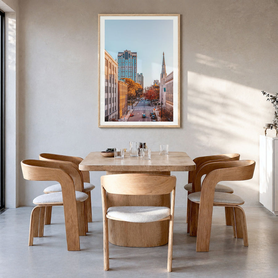 Raleigh Photo No 2 Poster in a natural wood frame, hanging in a dining room, white border