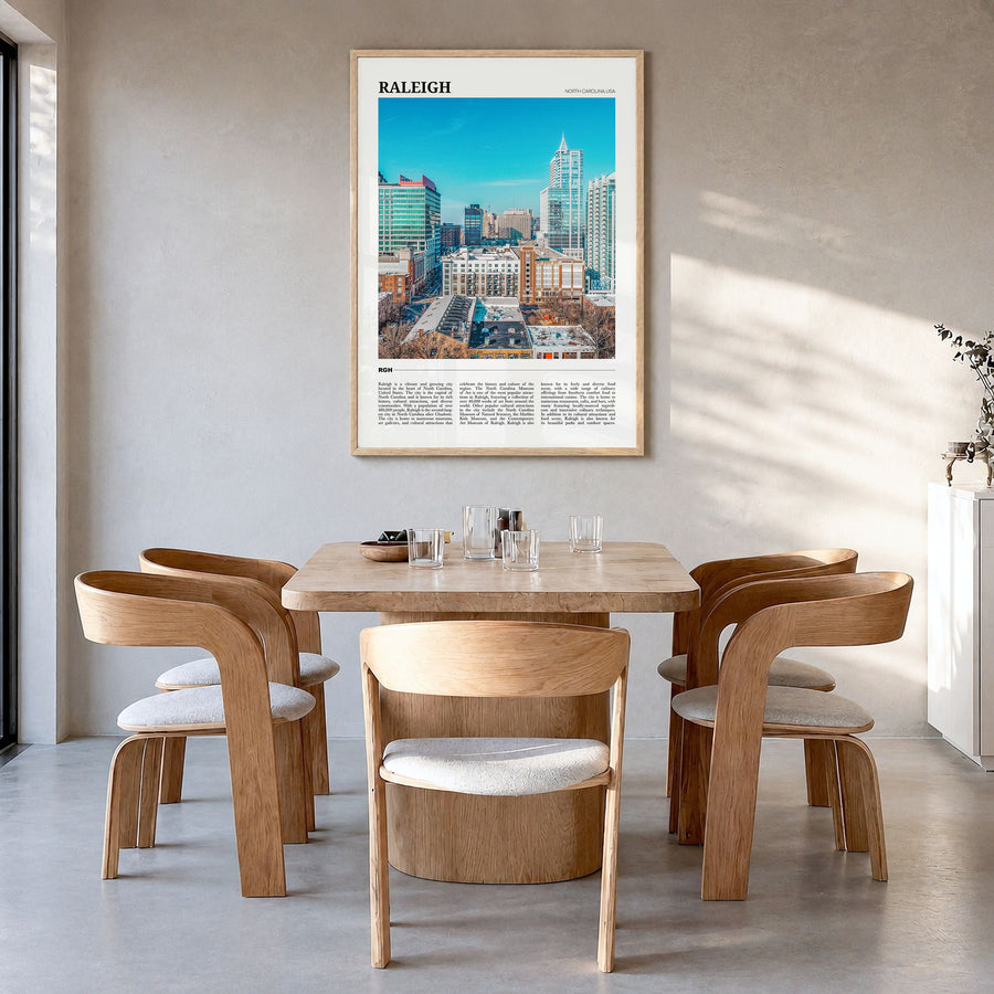 Raleigh Travel Poster in a natural wood frame, hanging in a dining room