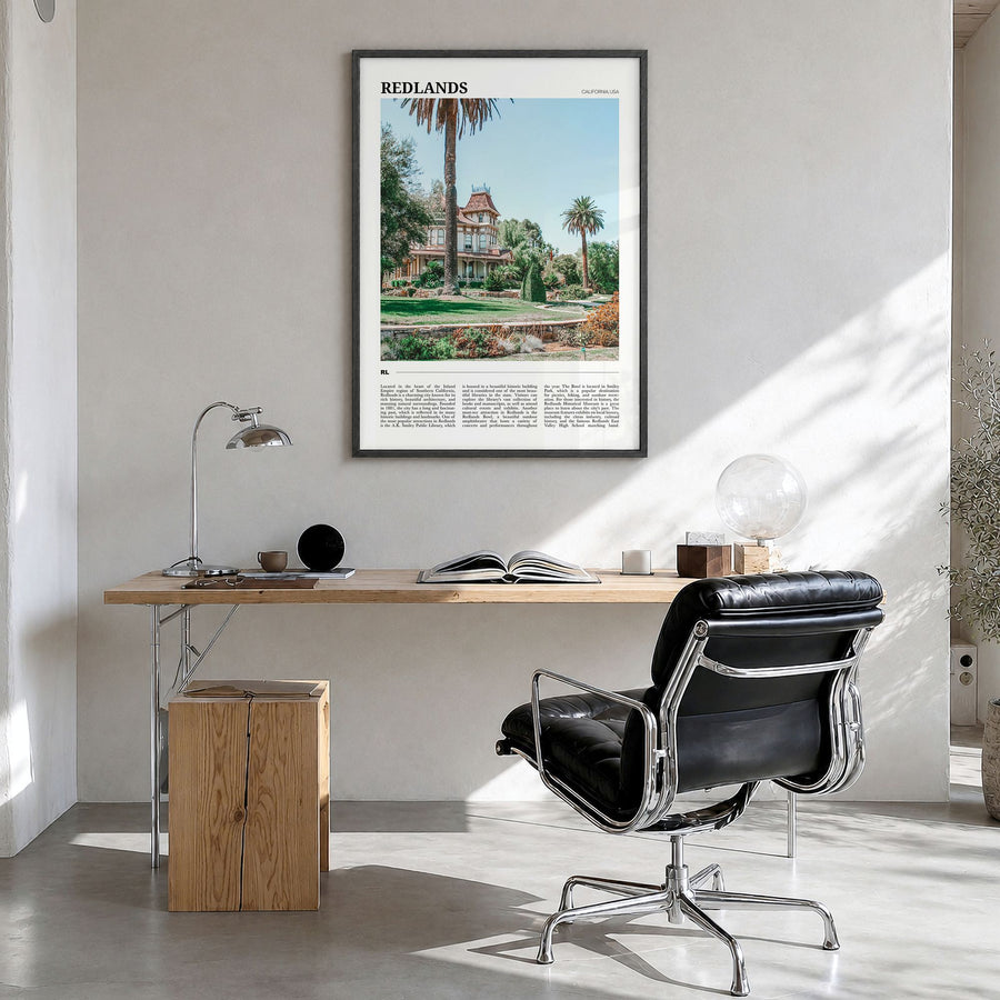 Redlands Travel Poster in a black wood frame, hanging in a bright home office