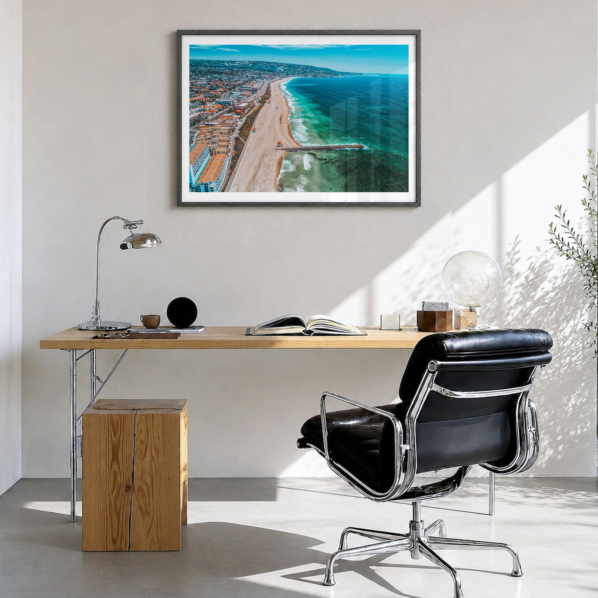 Redondo Beach Photo Poster in a black wood frame, hanging in a bright home office, white border
