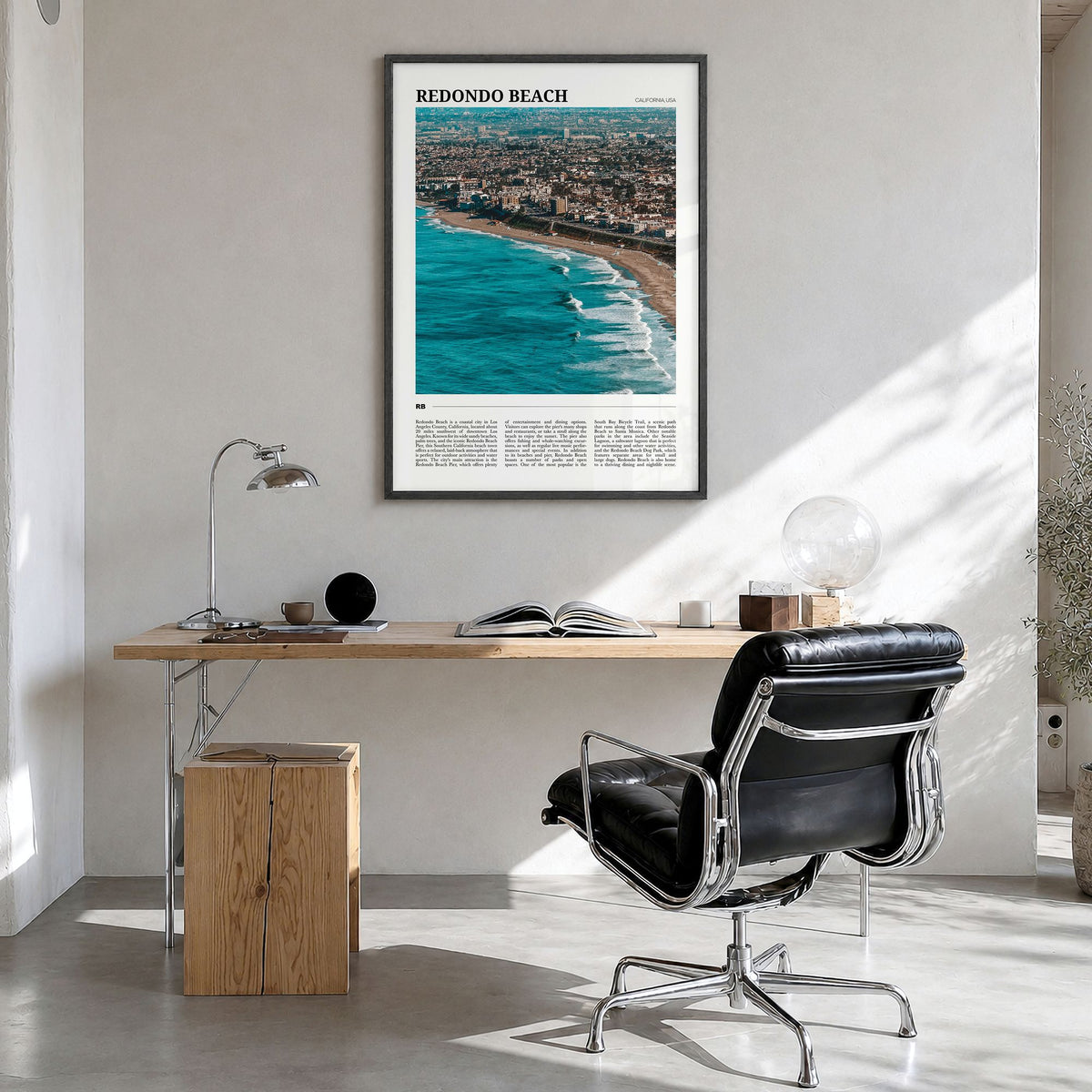 Redondo Beach Travel Poster in a black wood frame, hanging in a bright home office