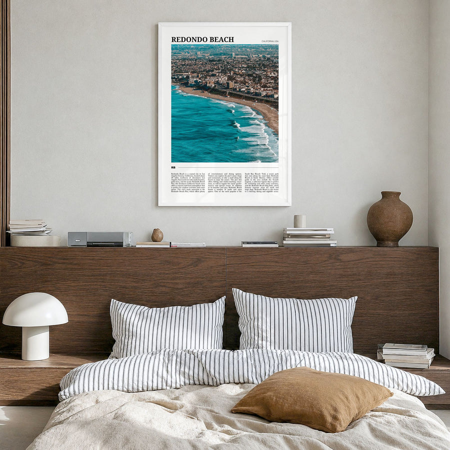 Redondo Beach Travel Poster in a white wood frame, hanging in a bedroom