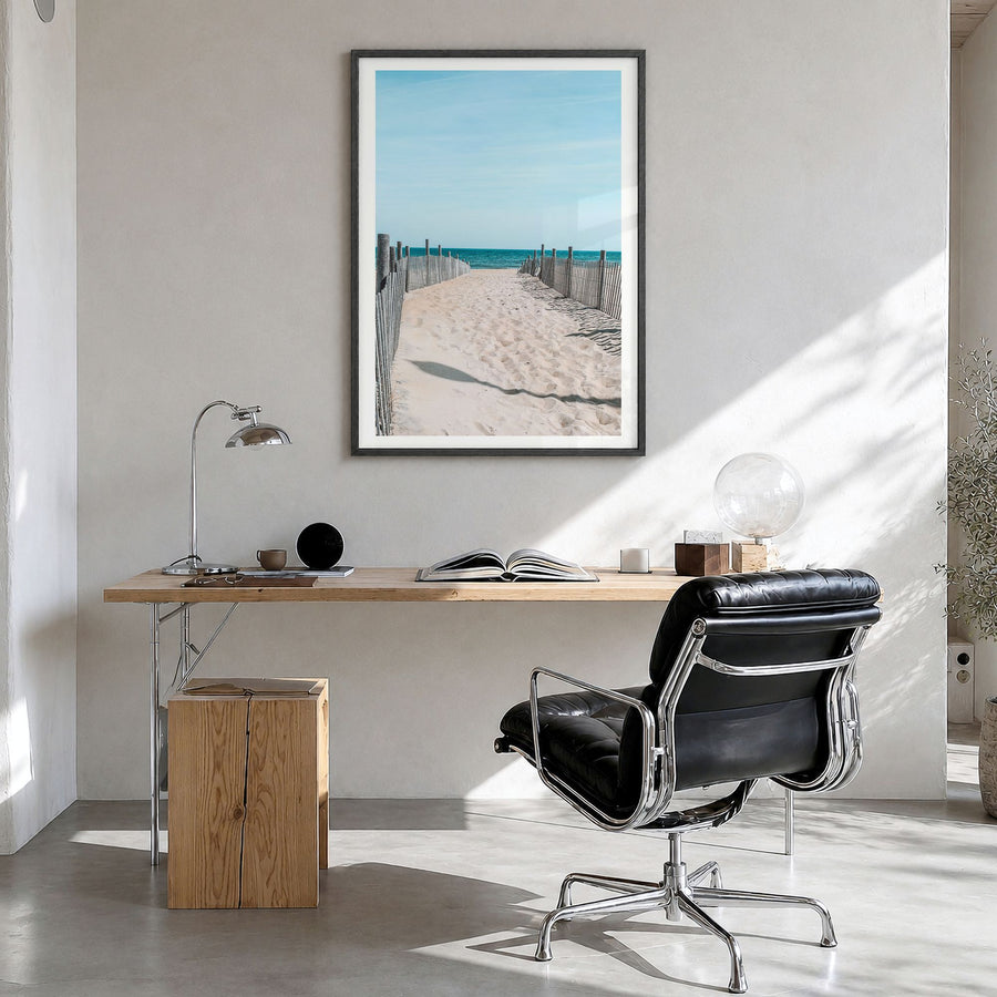 Rehoboth Beach Photo Poster in a black wood frame, hanging in a bright home office, white border