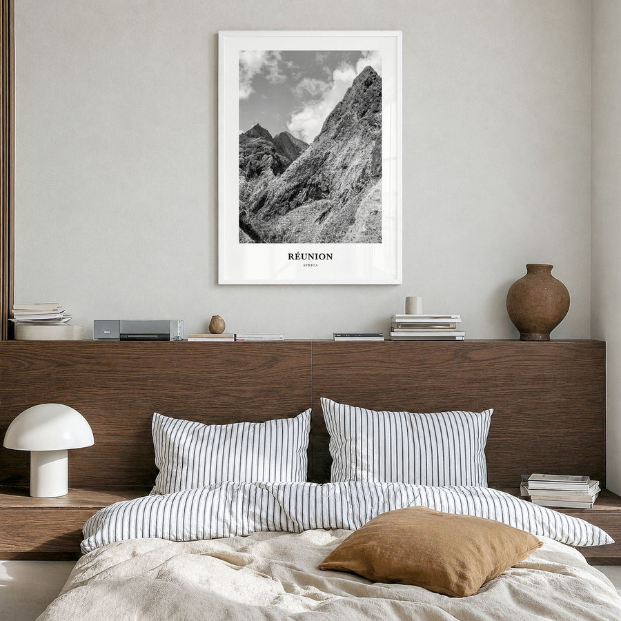 Réunion Classic Poster in a white wood frame, hanging in a bedroom