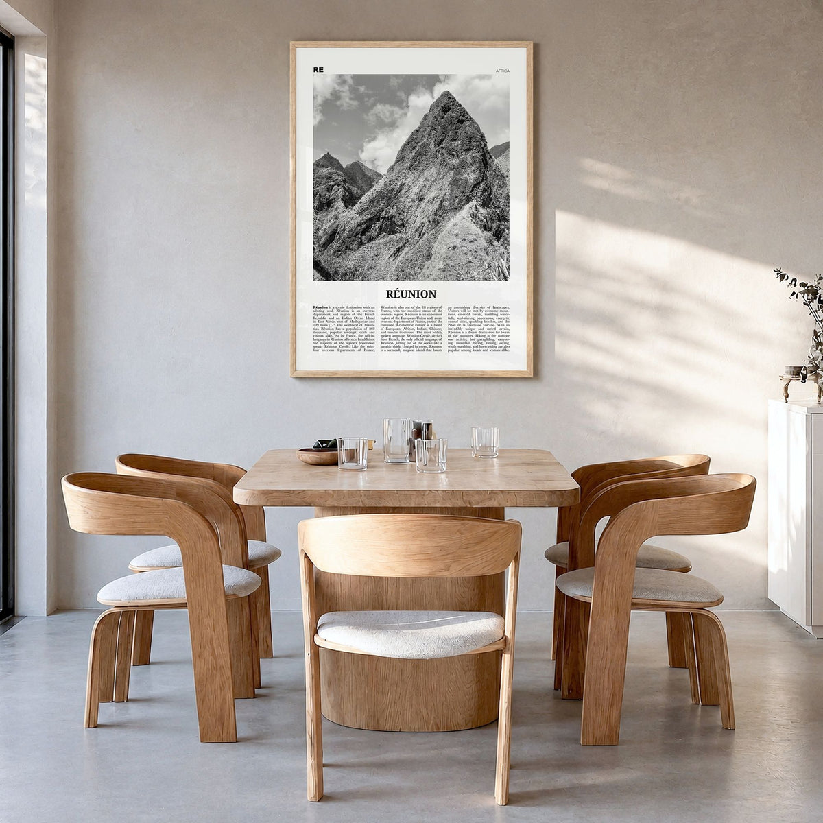Réunion Newspaper Poster in a natural wood frame, hanging in a dining room