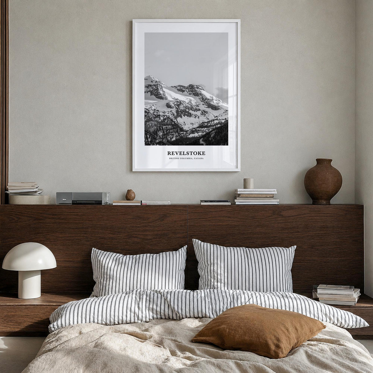 Revelstoke black & white classic poster of British Columbia, Canada – vertical wall art in white wood frame, hanging on wall